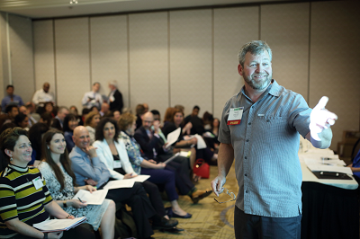 Presenter talking to group of participants