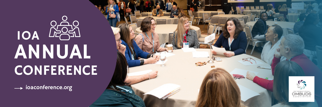 Annual Conference - People sitting around a table discussing.